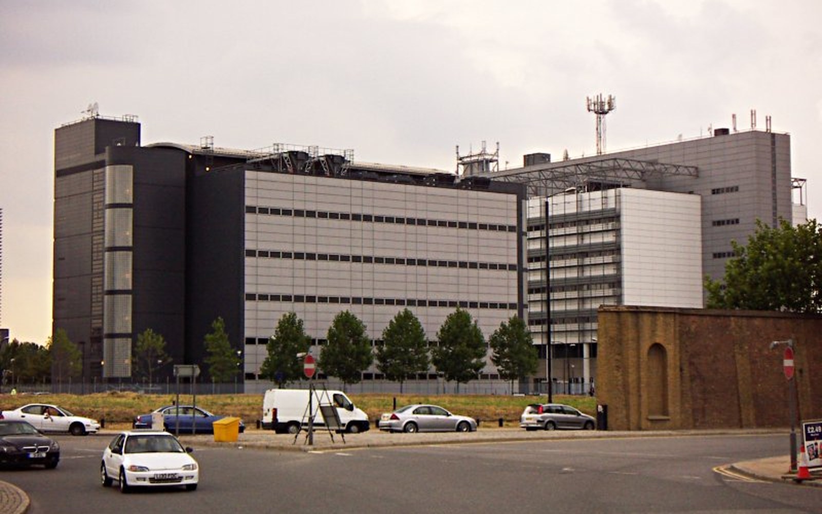 A large unmarked industrial building behind a fence